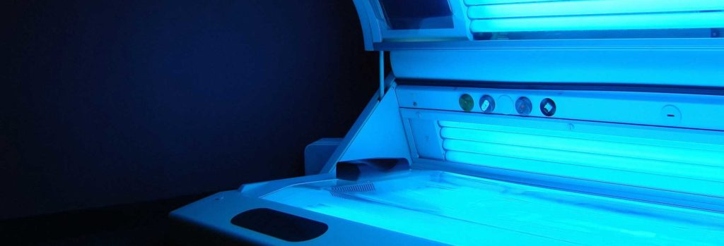 a pitcture of a tanning bed that is switched on and glowing blue
