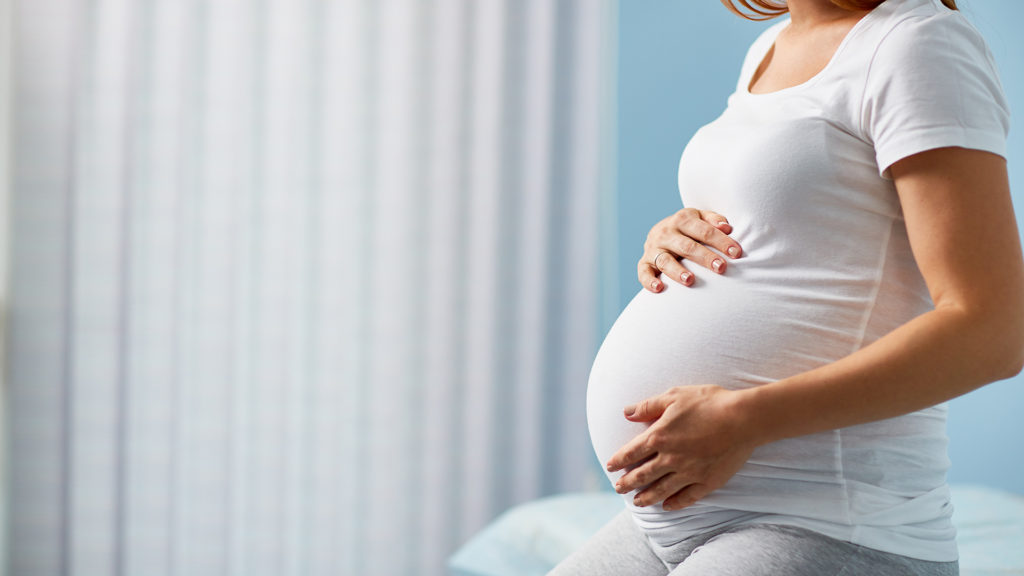 picture of a pregnant woman holding her belly